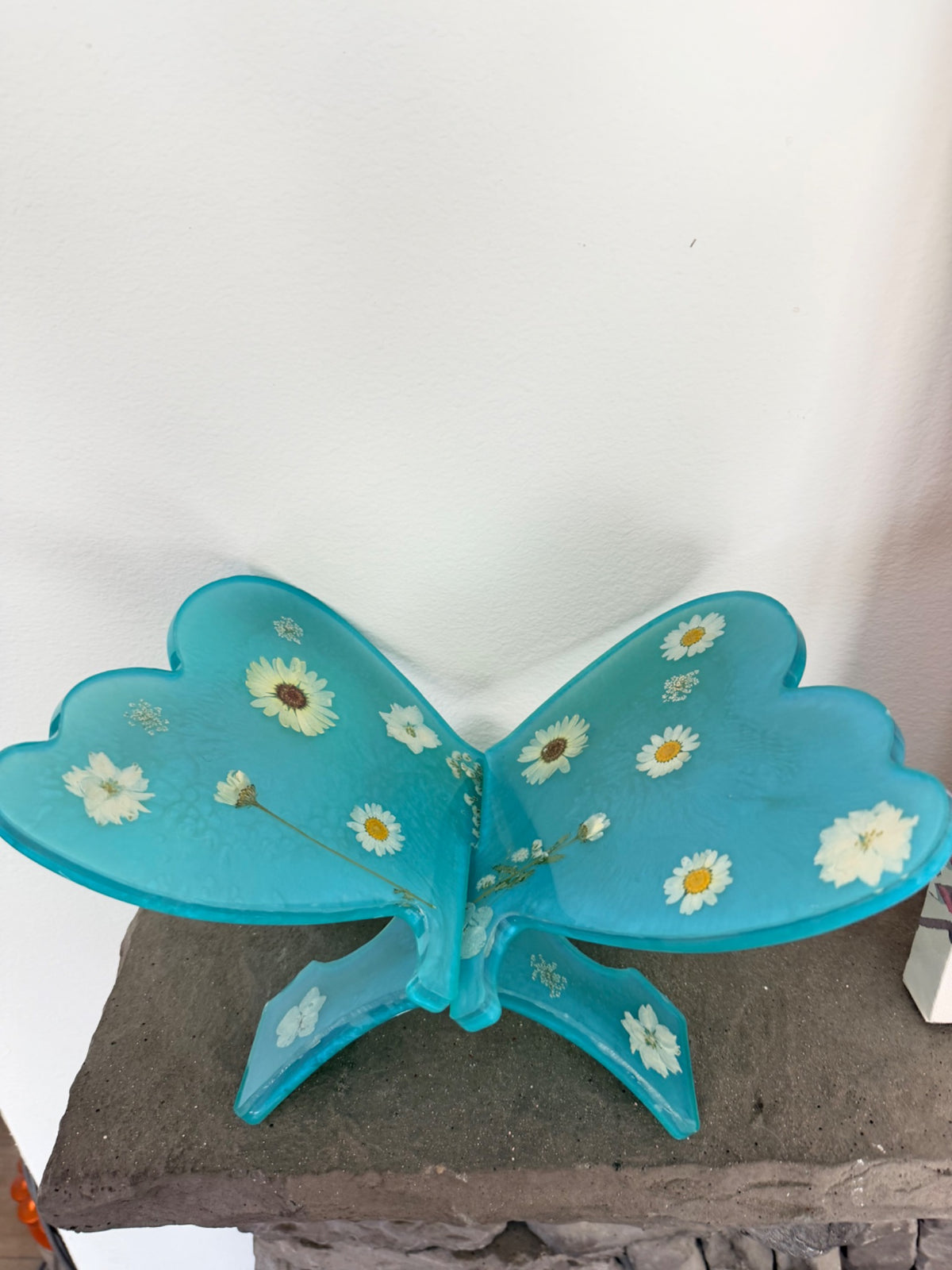 Turquoise butterfly-shaped resin book stand with dried flowers